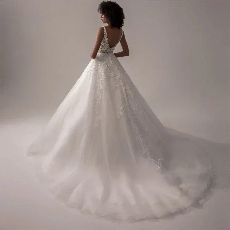 White wedding dress with intricate detailing on a plain background